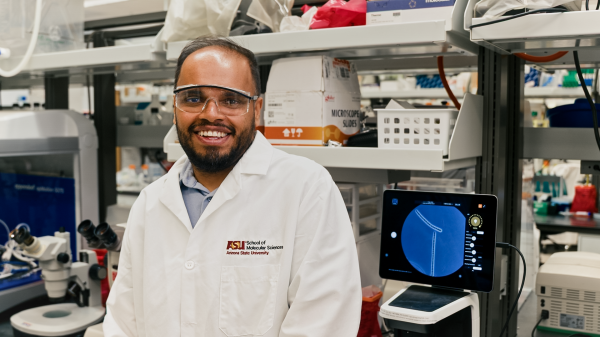 Glen D'Souza of the School of Molecular Sciences smiles in a lab